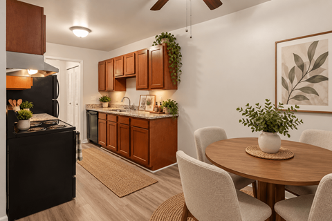 A kitchen with brown cabinets and a black refrigerator.