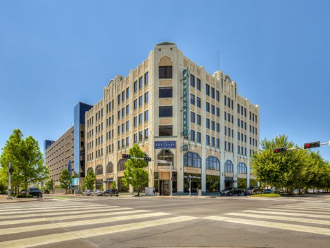 A large, beige building with a blue sign on the front.