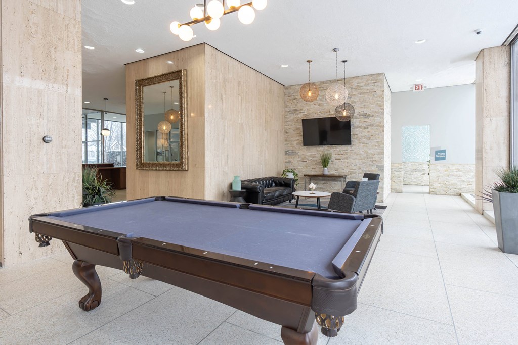 a pool table in the lobby of an office with a tv