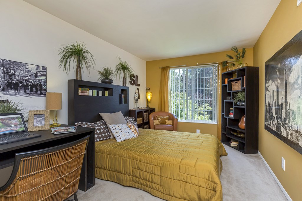 a bedroom with a large bed and a desk with a computer at Village Club of Rochester Hills, Shelby Township, MI 48317