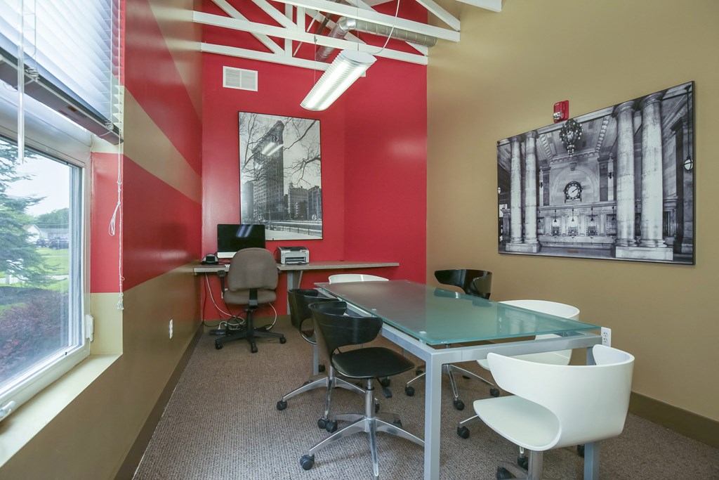 a conference room with a glass table and chairs and a window at Village Club of Rochester Hills, Shelby Township, MI 48317