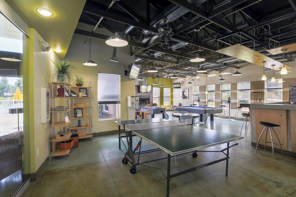 a room with a ping pong table in the middle at Village Club of Rochester Hills, Michigan, 48317