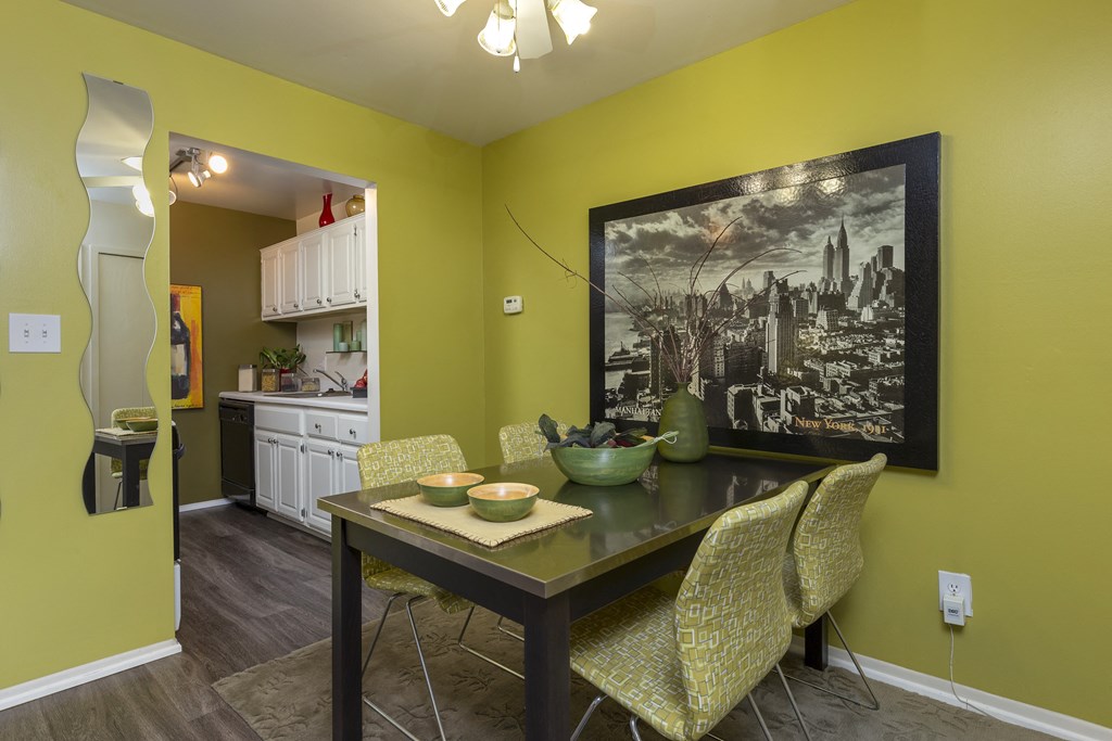 a dining room with a table and chairs and a painting on the wall at Village Club of Rochester Hills, Michigan, 48317
