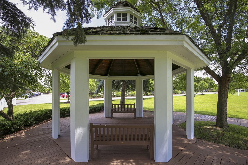 a gazebo in a park with a bench at Village Club of Rochester Hills, Shelby Township, MI