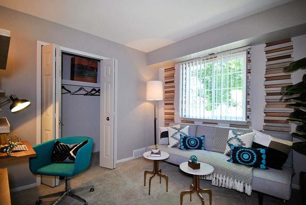 a living room with a couch and a window at Village Club of Rochester Hills, Shelby Township, MI