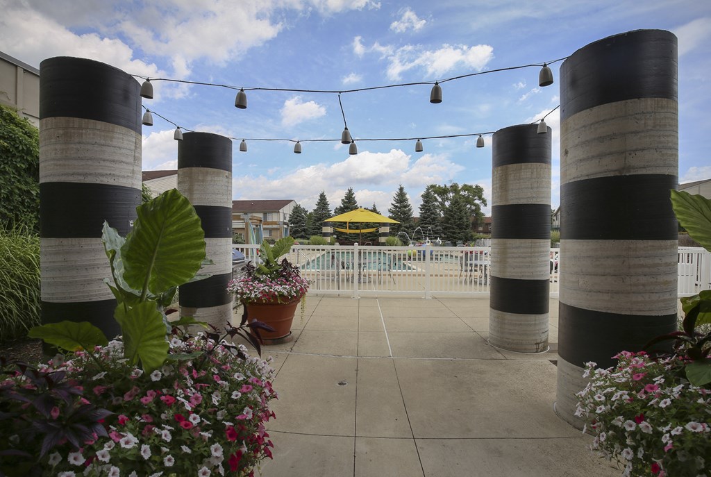 a pavilion with black and white striped columns and a yellow gazebo at Village Club of Rochester Hills, Shelby Township Michigan 