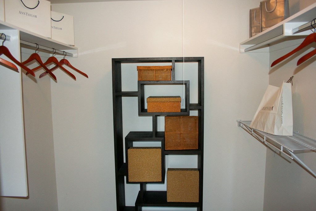 a closet with baskets and a shelving unit in it at Village Club of Rochester Hills, Michigan