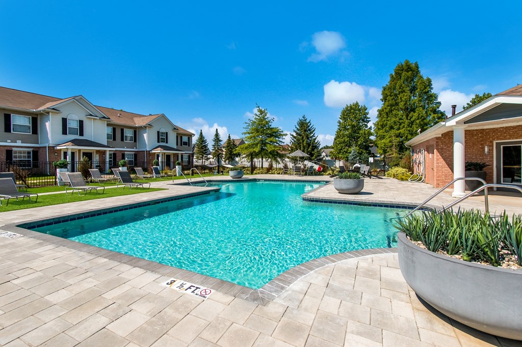 a swimming pool with a house in the background