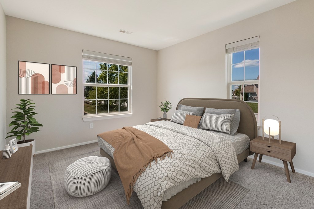 a bedroom with a bed and two windows
