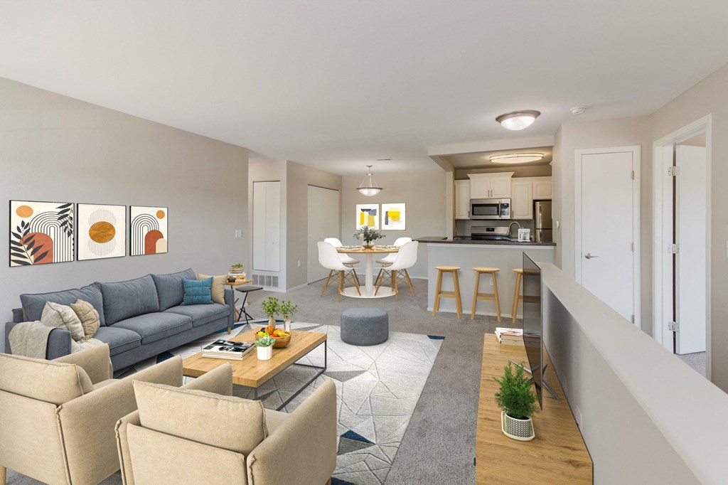 a living room and kitchen with couches and a table