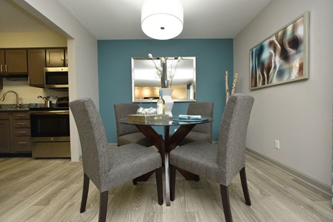 a dining room with a table and chairs