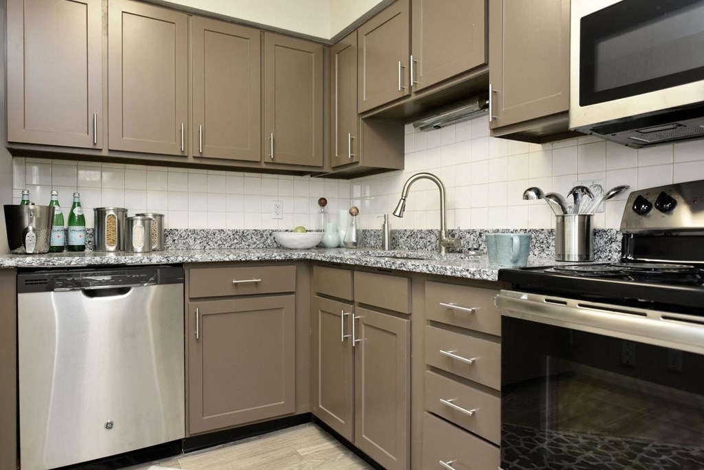 a kitchen with stainless steel appliances and granite counter tops