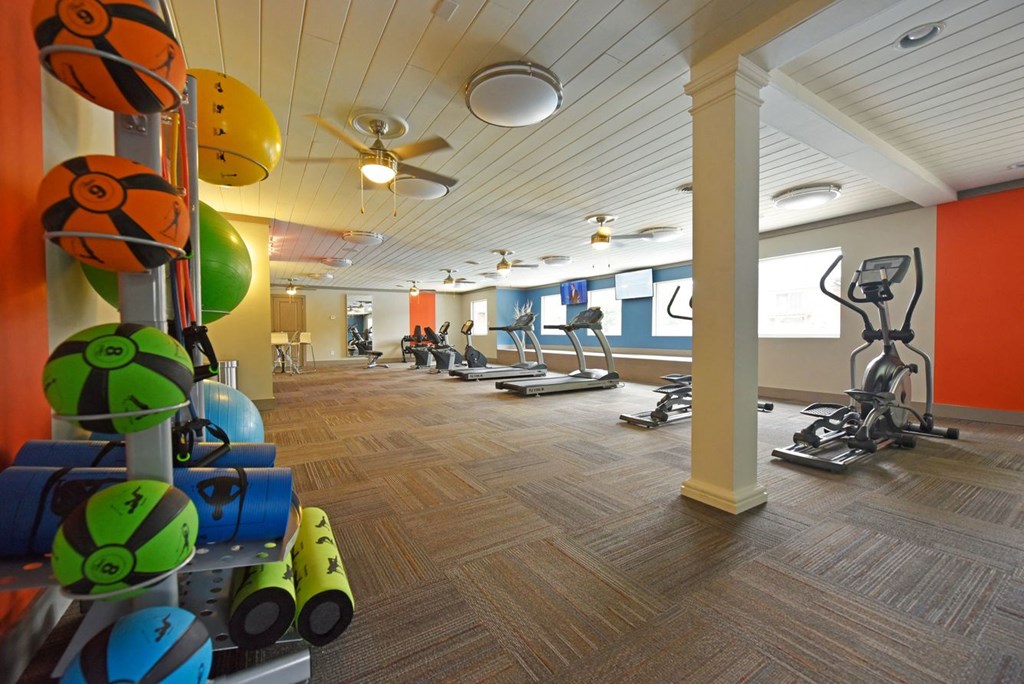 a gym with weights and other exercise equipment at aria on the avenue apartments
