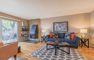 a living room with a couch coffee table and a fireplace