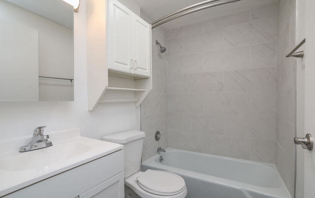 a bathroom with a sink toilet and a bath tub