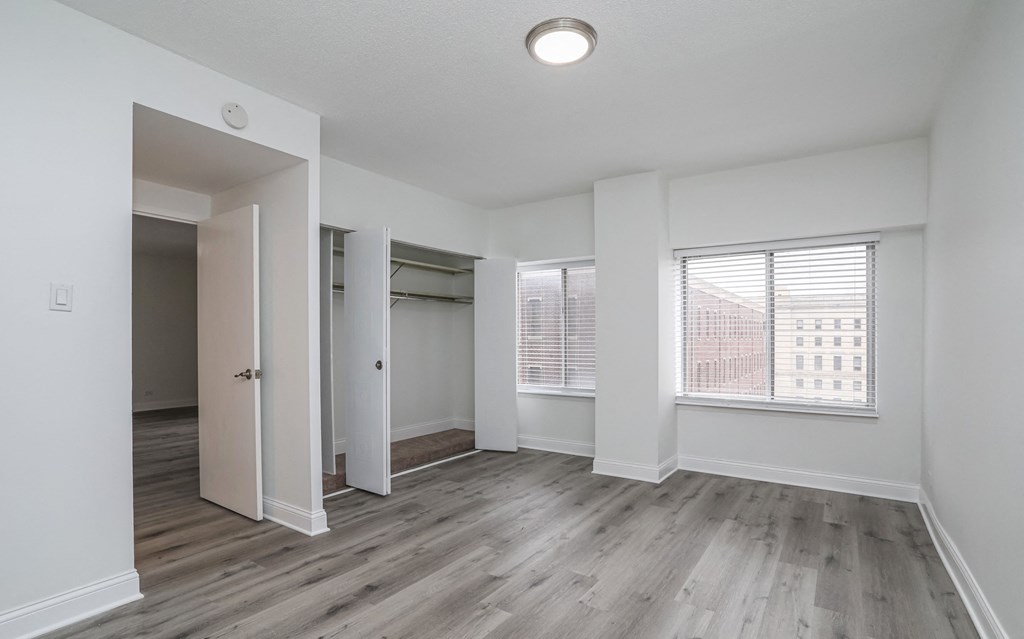 an empty living room with white walls and wood flooring