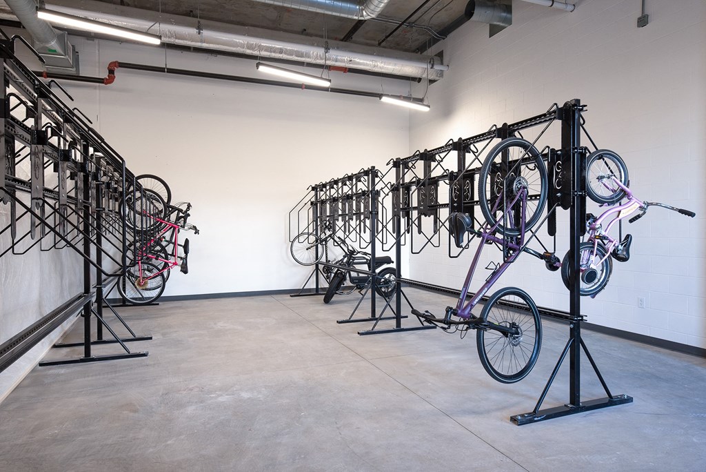 a group of bikes hanging on racks in a room