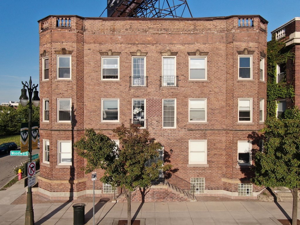 a large brick building with trees in front of it