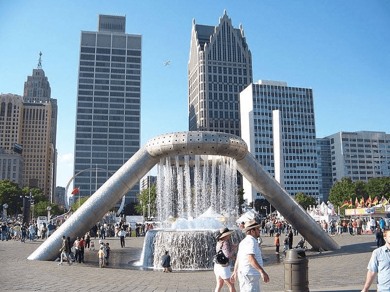 people walking around a fountain in a city at City Club Apartments Lafayette Park, Detroit, MI