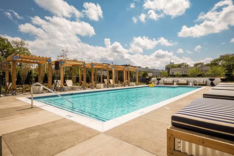 a swimming pool at a hotel with chairs around it at City Club Apartments Lafayette Park, Detroit