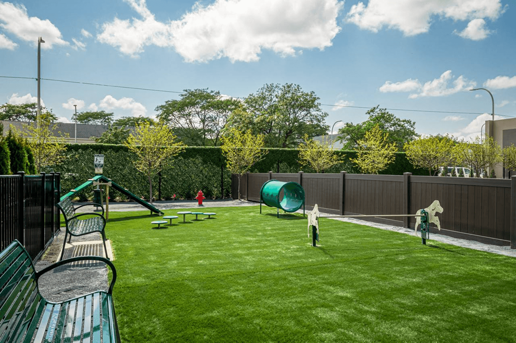 a backyard with a swing set and a playground at City Club Apartments Lafayette Park, Michigan
