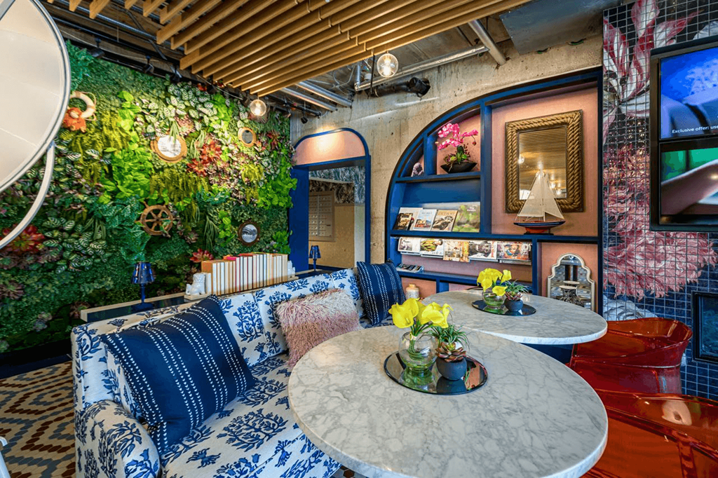 a living room with blue and white furniture and a green wall at City Club Apartments Lafayette Park, Michigan 48207