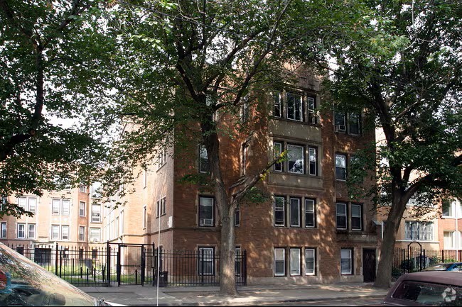A brown building with a black fence in front of it.