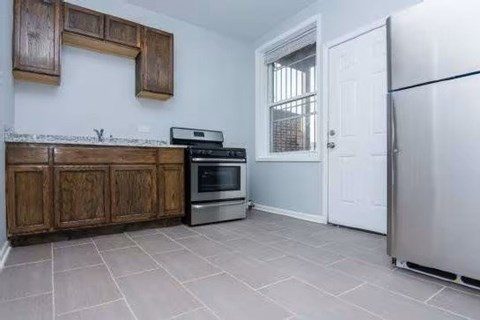 A kitchen with a stove, oven, and refrigerator.