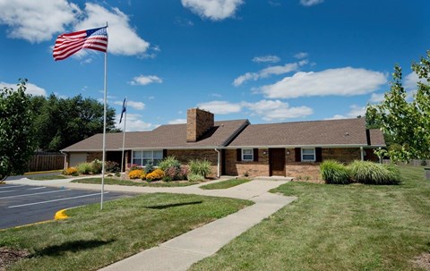 A building with a flag on a pole in front of it.