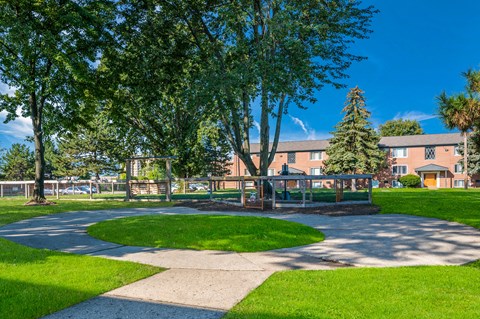 A park with a grassy area and a walking path.