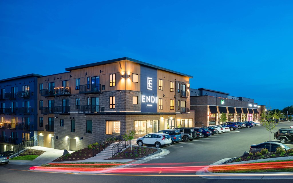 The image shows a building with the word "ENDLESS" on it, surrounded by parked cars.
