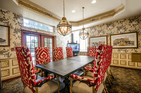 Formal dining room with upholstered chairs and pendant lighting at Regents Club of Troy Apartments, Troy, MI