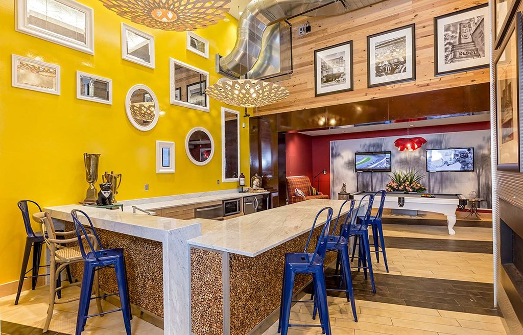 a bar with blue chairs at a restaurant with a pool table a bar with blue chairs at a restaurant with a pool table at Ann Arbor City Club, Ann Arbor, 48104