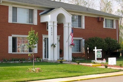 Red brick building with white pillar entrance.