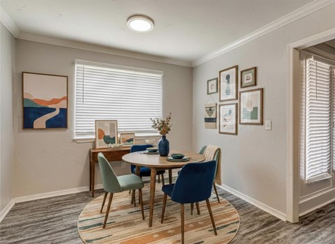 A dining room with a table set for four.