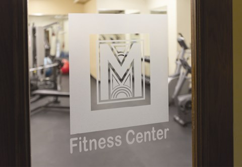 A sign in a gym that says Fitness Center.