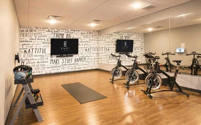 A gym with exercise bikes and motivational wallpaper.