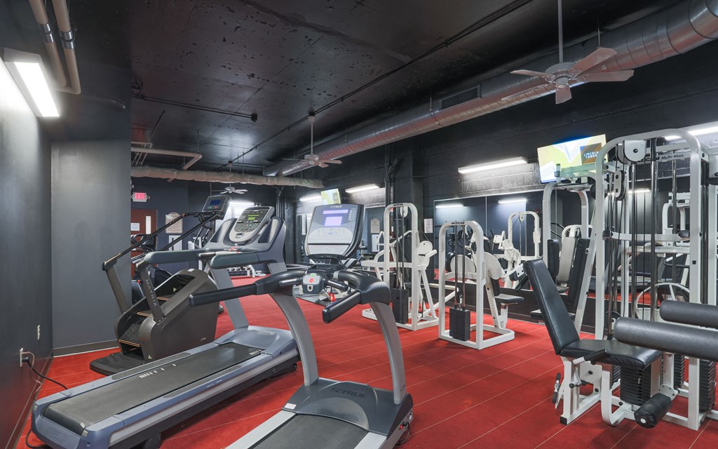 a gym with treadmills and other exercise equipment