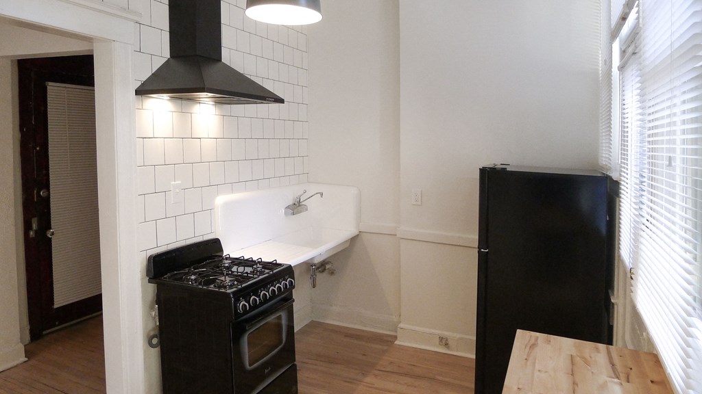 a small kitchen with a stove and a refrigerator