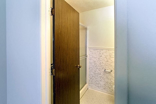 a bathroom with a shower and a toilet in it