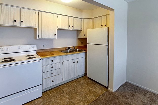 a kitchen with white appliances and white cabinets