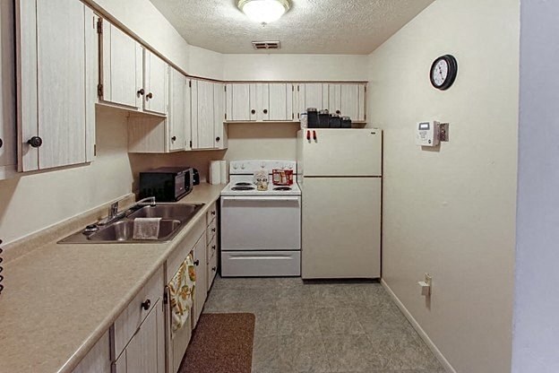 a kitchen with a refrigerator stove and sink