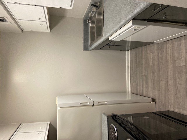 Renovated kitchen area with white appliances