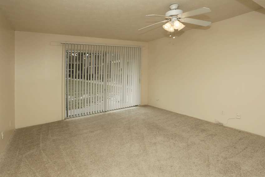 Carpeted living room with doorwall