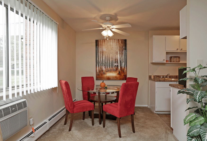 a dining room with a table and chairs and a ceiling fan