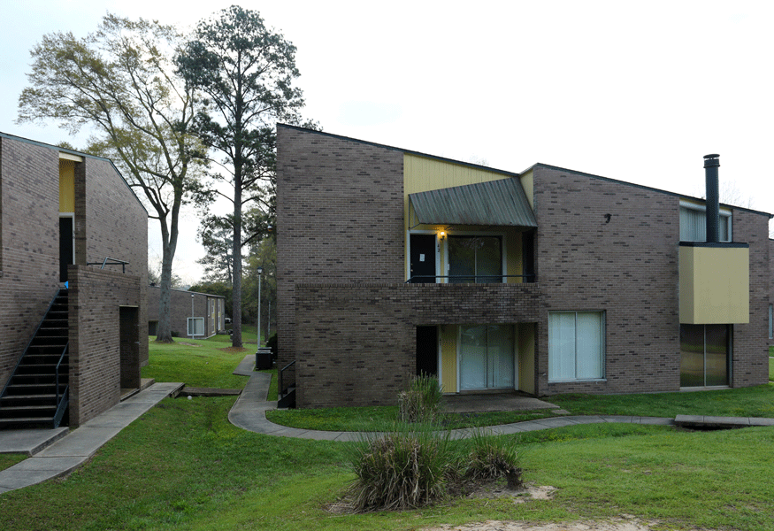 Brick exterior of North Gate with lush green grass in front of it.
