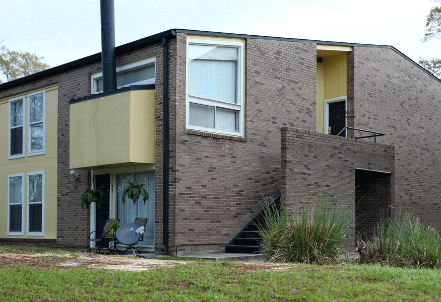 Exterior of brick building at North Gate with yellow balconies.