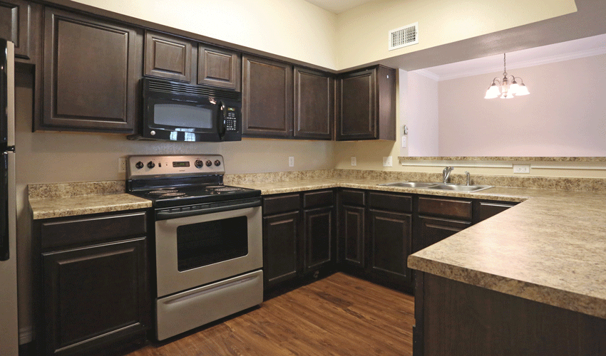 a kitchen with stainless steel appliances and marble counter tops