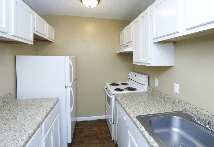 White kitchen with white and tan contertops.