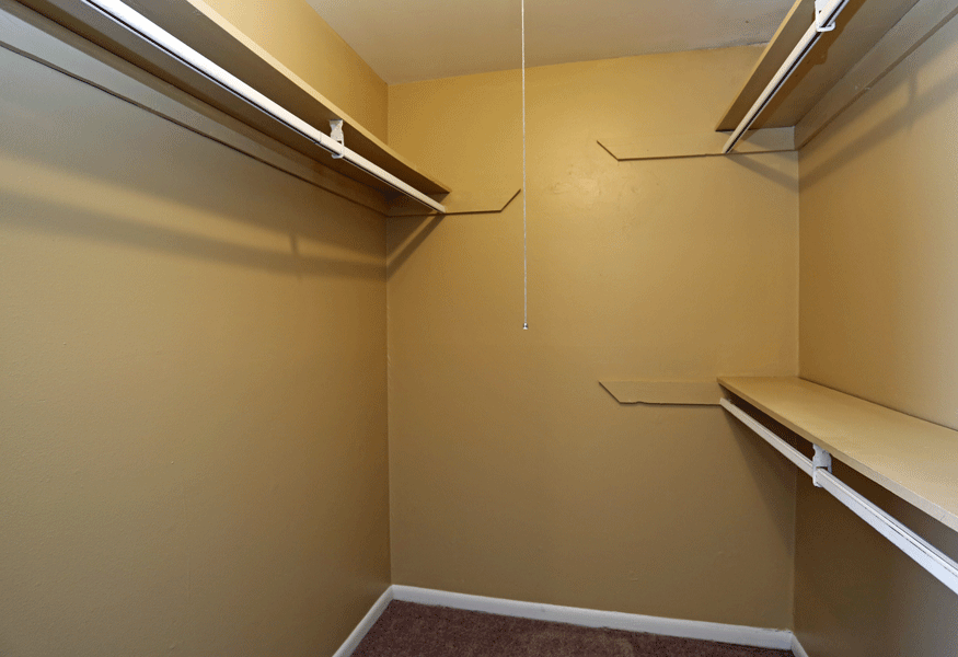 Large walk in closets with shelves.